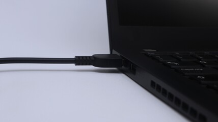 Laptop being charged on white background