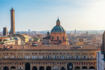 Aerial view of Bologna old town, Emilia Romagna, Italy with Palazzo dei Banchi with arched porticoes and Dome of the Basilica of San Pietro at sunrise and towers. Travel destination in Europe © samael334