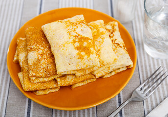Delicious pancakes stuffed with liver and egg served on platter for breakfast