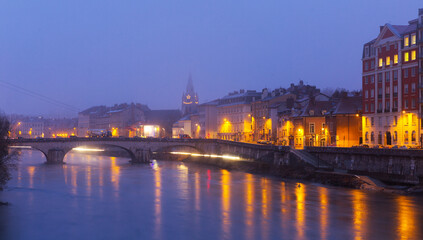 Cityscape of Grenoble with Isere river at winter twilight
