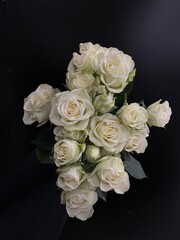 bouquet of white mini roses on black