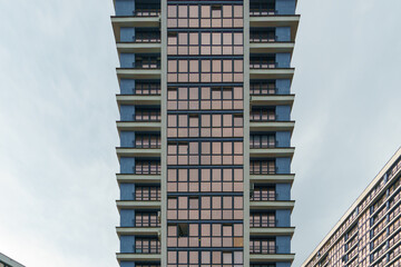 Fototapeta premium Modern skyscrapers in the new area. Tall buildings made of glass against the sky. Buying or renting luxury real estate.