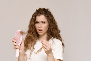 Woman scared, nervous, expression as she notices hair thinning and hair falling out. Hair loss...