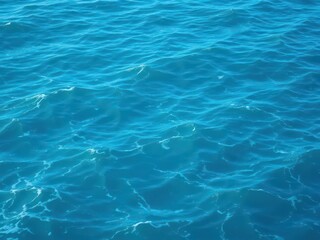 Obraz premium Smooth pure blue turquoise water texture of the ocean sea with white foam and gentle waves creating a serene and calming natural background, blue, natural, serene