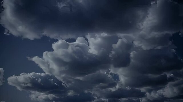 Seamless looping atmospheric dark clouds drifting slowly in moody sky at night