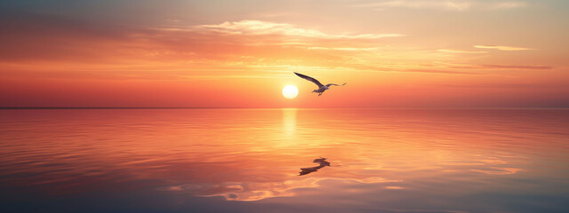 Obraz premium Peaceful sunrise over calm waters with two birds flying together in warm tones