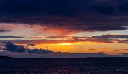 Sunrise Over Calm Waters Under Vibrant Skies on the West Coast