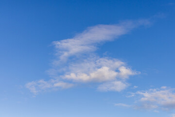 Serene Blue Sky with Delicate White Clouds in a Sunny Atmosphere