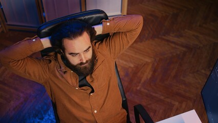 Outraged software engineer perplexed by impossible to remove bugs appearing while coding on computer desktop. Teleworking IT admin feeling baffled by script errors, putting hands on head, camera B