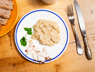 Appetizing lard with hot oatmeal and parsley. Hearty healthy dish