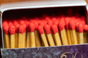 Several red-headed phosphor sticks arranged inside the box