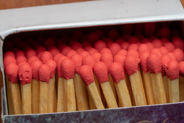 Several red-headed phosphor sticks arranged inside the box