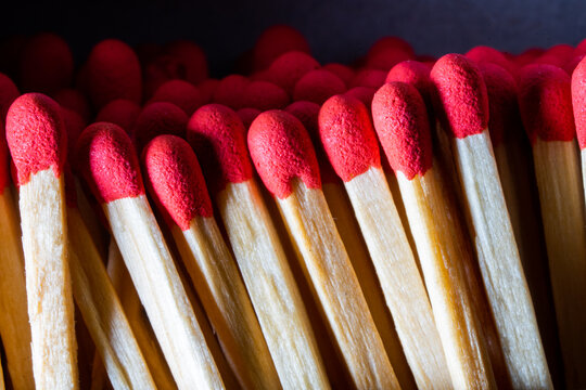 Several red-headed phosphor sticks arranged inside the box