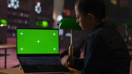 Librarian completing notes on learning materials next to isolated display, help students with academic success and preparing for tutoring session in the library. Private lessons. Camera B.