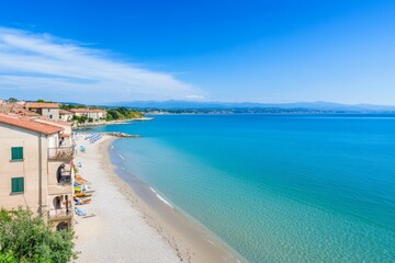 Obraz premium A beach with a blue ocean and a few buildings in the background
