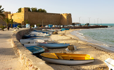 Town of Hammamet in Tunisia, Africa. View of ancient fort, coastline and fishing boats