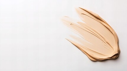 Swirl of light beige foundation cream on a white background.  A smooth, elegant texture perfect for beauty or cosmetics promotion.