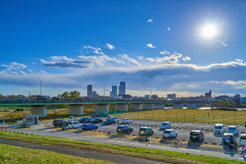 Fototapeta premium 東京都大田区の多摩川河川敷からガス橋、緑地駐車場、川崎市上平間方面を見る