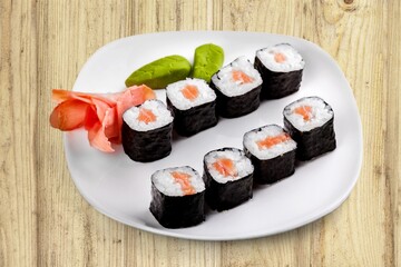 Fresh tasty sushi rolls on plate