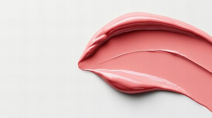 Swirl of glossy, pale pink lip gloss on a white background.  Smooth texture and rich color.