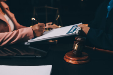 Judge gavel with Justice lawyers having team meeting at law firm background. Concepts of Law and Legal services.