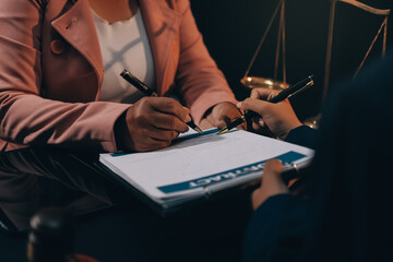 Judge gavel with Justice lawyers having team meeting at law firm background. Concepts of Law and...