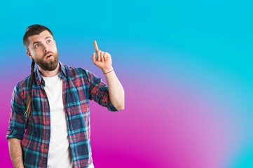 Naklejka premium Portrait of attractive man pointing fingers at background.