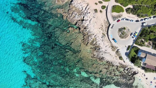 Discover the breathtaking beauty of Cala Agulla in Cala Rajada, Mallorca, where turquoise waters meet rocky shores, creating a perfect spot for swimming and relaxation amidst nature's wonders.