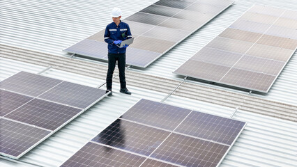 technician in hard hat and safety gear inspects solar panels on a metal rooftop, holding a tool. The scene emphasizes renewable energy, solar technology, and maintenance of sustainable infrastructure.