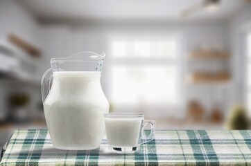 Tasty fresh milk into glass at light kitchen