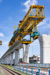 Fototapeta premium New construction site with crane and mechanical equipments on sunset daylight background. construction industry.High-speed train of Chinese made FuxingHao, base from CR400AF For Thailand.