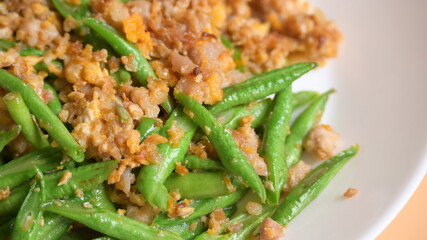 fried green bean with pork on white plate, thai and chinese food