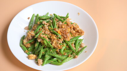 fried green bean with pork on white plate, thai and chinese food