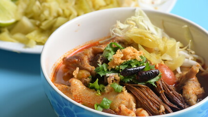 rice vermicelli with northern thai curry sauce on blue background