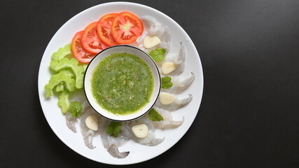 shrimp in fish sauce with Thai spicy seafood dipping sauce on white plate