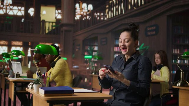 Rude woman answering a phone call in the library and disturbing people, being very noisy. Clients asking her to keep quiet, losing focus and concentration while learning or reading. Camera A.