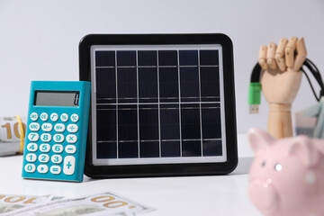 Portable solar panel with calculator and money