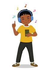 Cute little African boy listen to music with headphone 