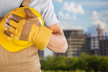 Fototapeta premium Safety workwear hold safety helmet at construction