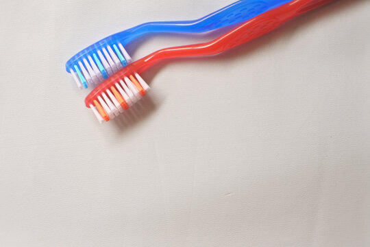 red toothbrush with toothpaste. red and blue toothbrush isolated on white background
