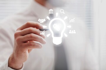 Business solution concept. Businessman hold light bulbs