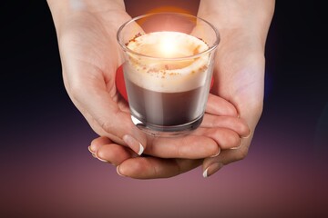 Hands of person hold a candle at dark background