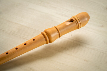 Naklejka premium wooden recorder flute instrument, classic German style, against wood