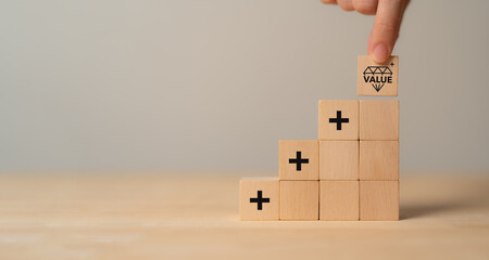 Value added concept. Way to adding value to product and service. Wooden blocks with value added...