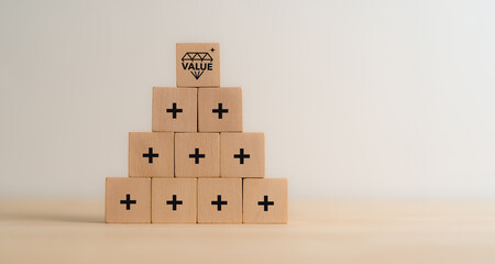Value added concept. Way to adding value to product and service. Wooden blocks with value added...