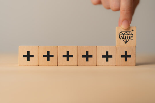 Value added concept. Way to adding value to product and service. Wooden blocks with value added icons. Improving products, excellent service, expert advice, consistently upgrade, deliver fast.