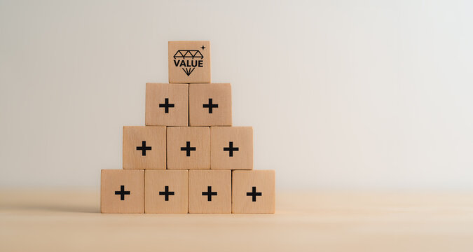 Value added concept. Way to adding value to product and service. Wooden blocks with value added icons. Improving products, excellent service, expert advice, consistently upgrade, deliver fast.