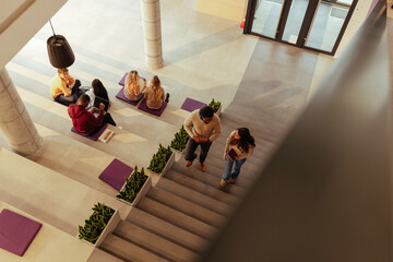 University students walking down stairs in modern building