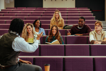 Professor engaging with students during university lecture in amphitheater