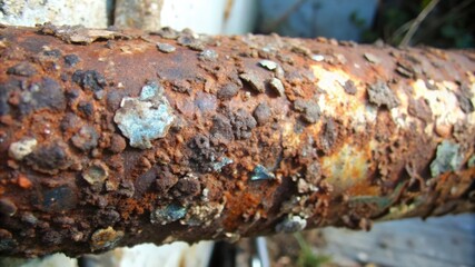 Fototapeta premium Close-up of a Rusted Metal Pipe with Flaking Paint